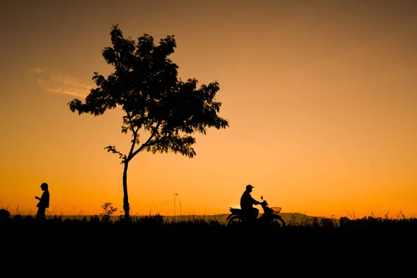 Silhouette dell'agricoltore che guida moto sul campo — Foto Stock