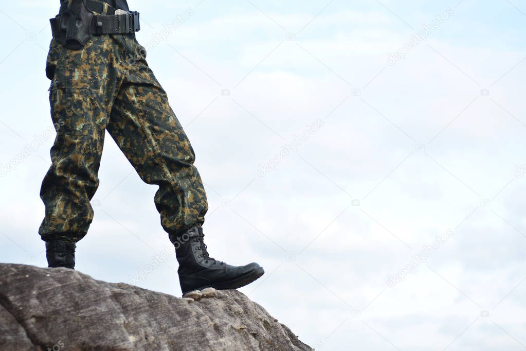 Soldier stand on the rock in nature background