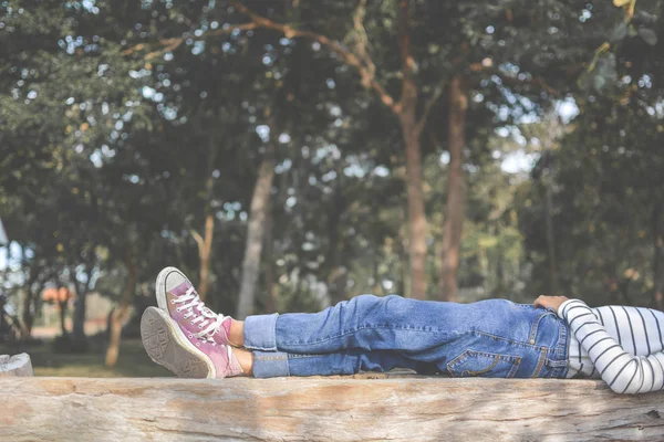 Feet of young girl sleep in the park on nature