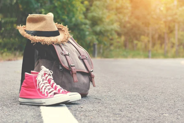 Brown bag red sneaker with hat on road and nature background  accessories backpack to travel — Stock Photo, Image