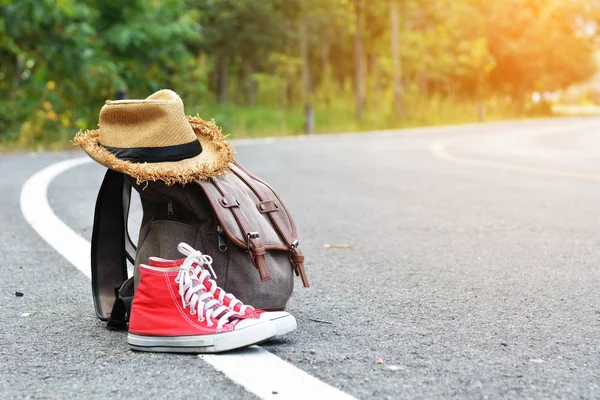 Brown bag red sneaker with hat on road and nature background  accessories backpack to travel — Stock Photo, Image