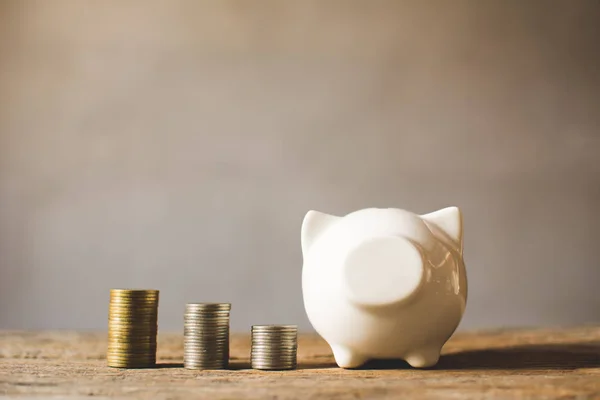 coin with piggy bank on old  background, a color of vintage tone