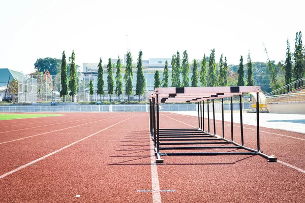 hurdle race on stadium track