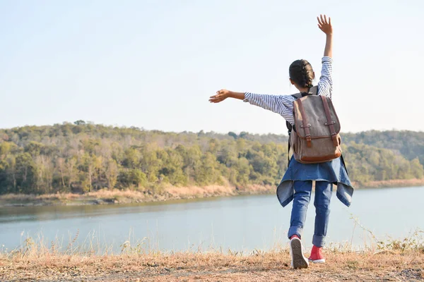 Happy Asian girl backpack  in nature background — Stock Photo, Image