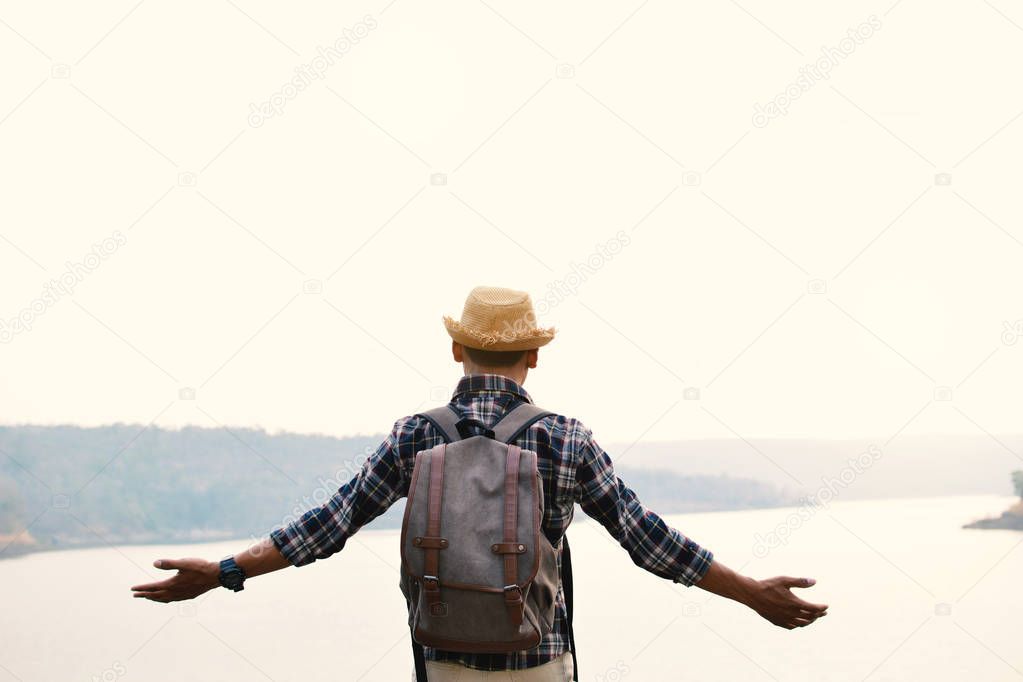 Happy Asian hipster man backpack in nature background