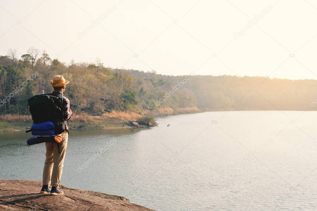 Happy Asian hipster man backpack in nature background