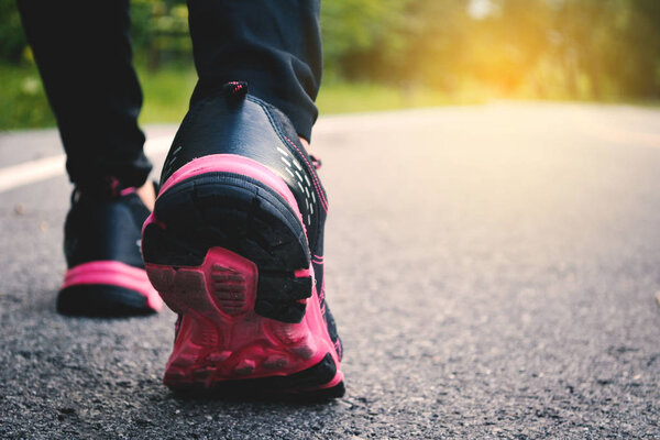 Feet women running on the road for health