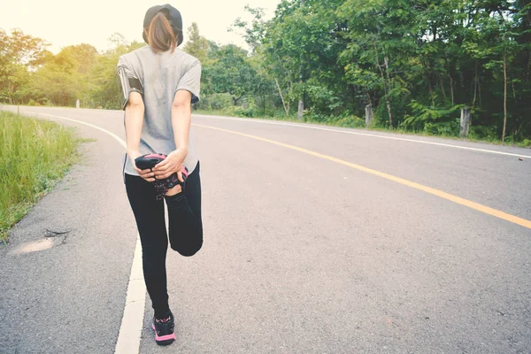 Women running on the road for health, color of vintage tone sele