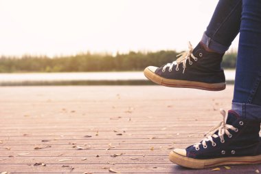 Park ve doğa arka planda hipster kadınların ayakları