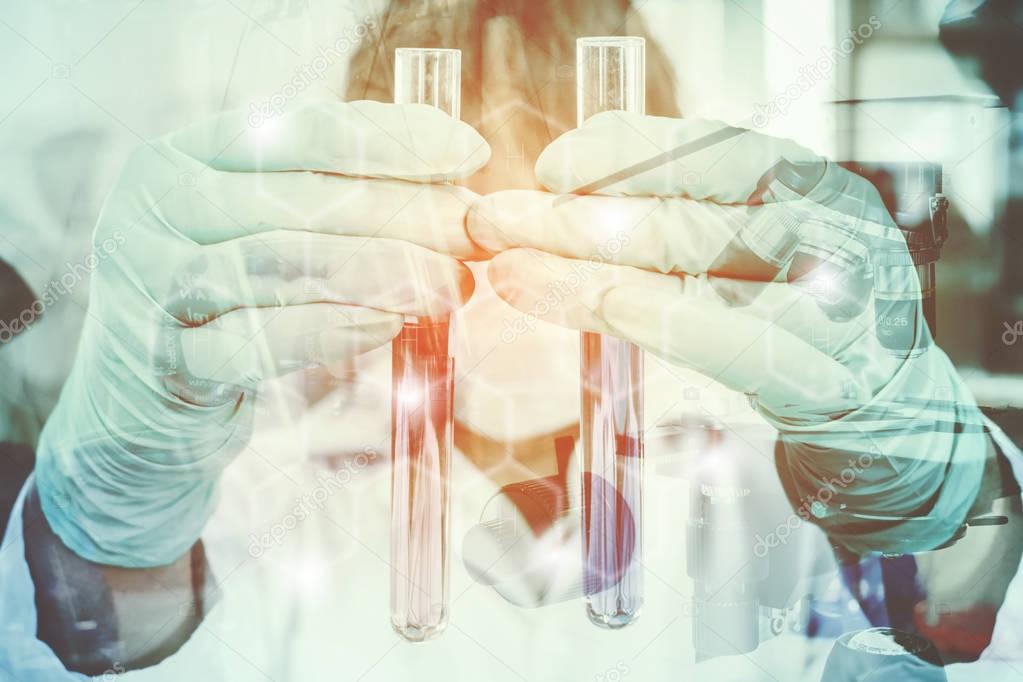Double exposure of science experiment  hand holding test tube