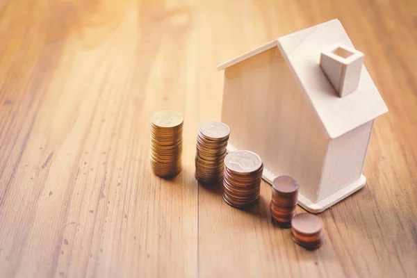 Coins and wood house on table concept save money for home — Stock Photo, Image