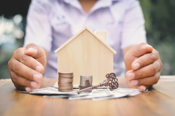 Hands boy holding little wood house and coins concept save money for my home — Stock Photo, Image