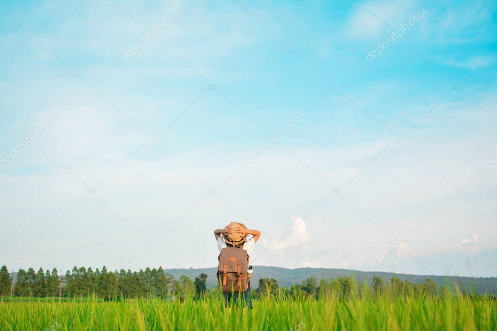 Happy girl backpack in green field