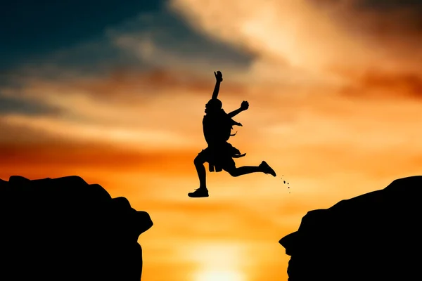 Silhouette of boy jumping at sky sunset — Stock Photo, Image