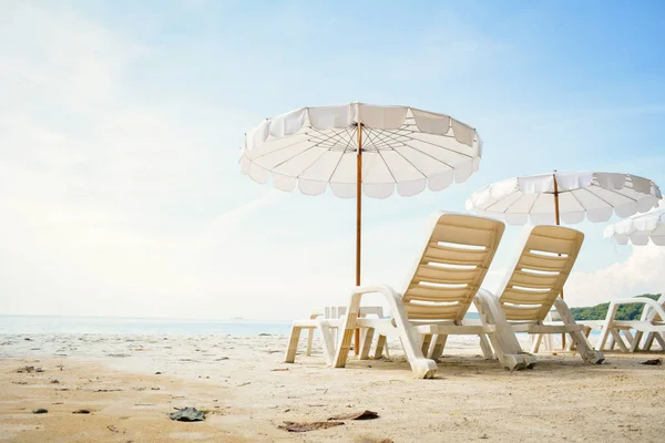 White chair with sun umbrella in the beach on seafront