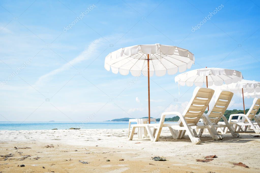 White chair with sun umbrella in the beach on seafront , relax time on vacation