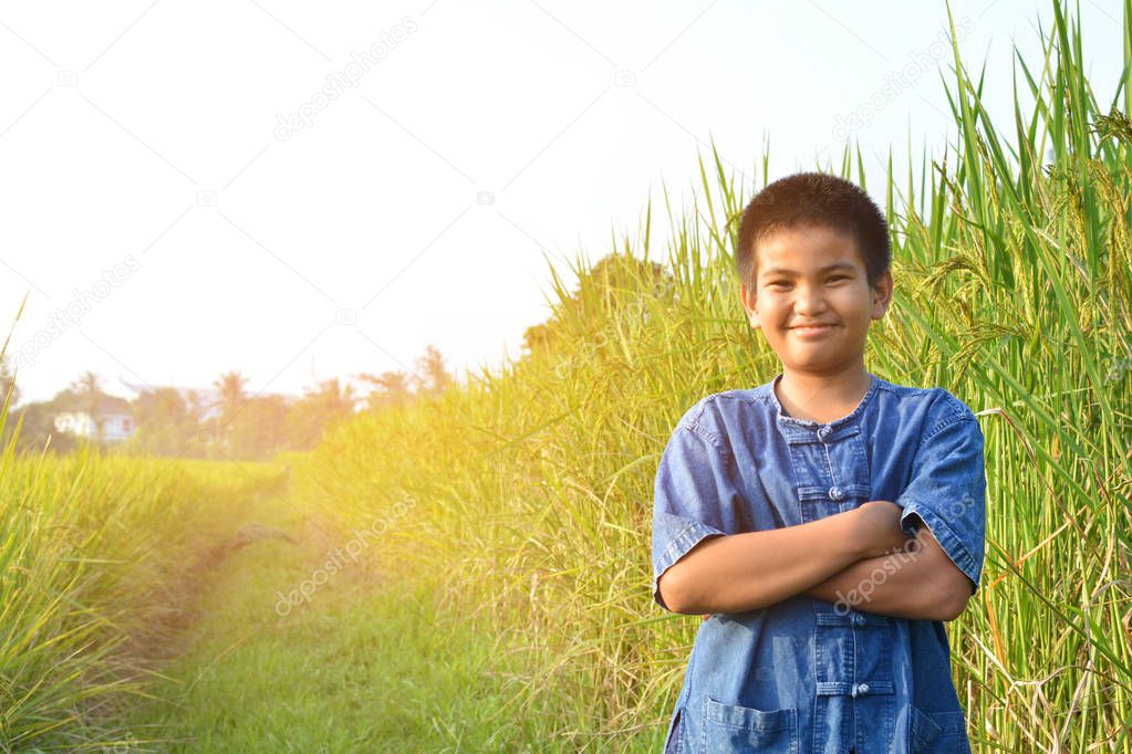 Happy little farmer on rice field
