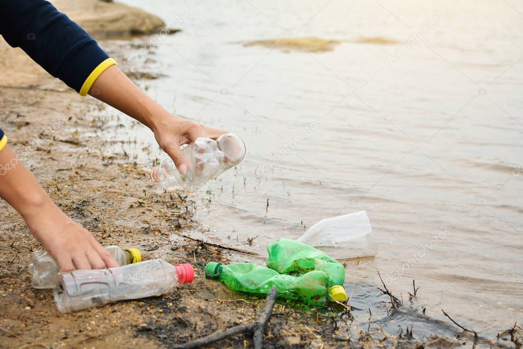 Man picking up empty of bottle plastic ,volunteer concept