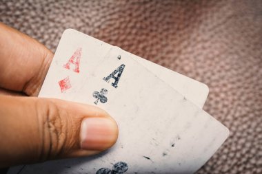 Eski iskambil kahverengi deri arka planda tutan el