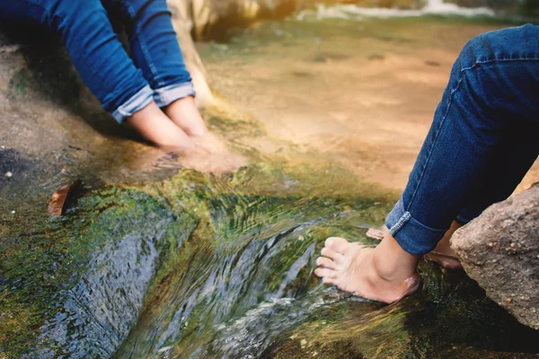 Feet of children in water on the forest, Relax time and vacation concept