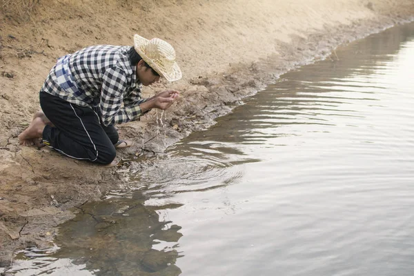 Asian man on nature ,crisis of water drought concept, selective and soft focus