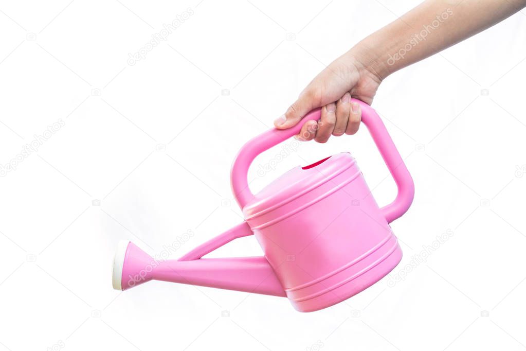 Close-up girl hand holding pink watering can on a white background