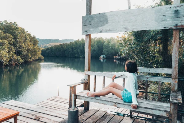 The cute girl enjoys the natural resting and looking on the river and mangrove view. — Stock Image Cute Girl Enjoys Natural Resting Looking River Mangrove View Royalty Free Stock Images