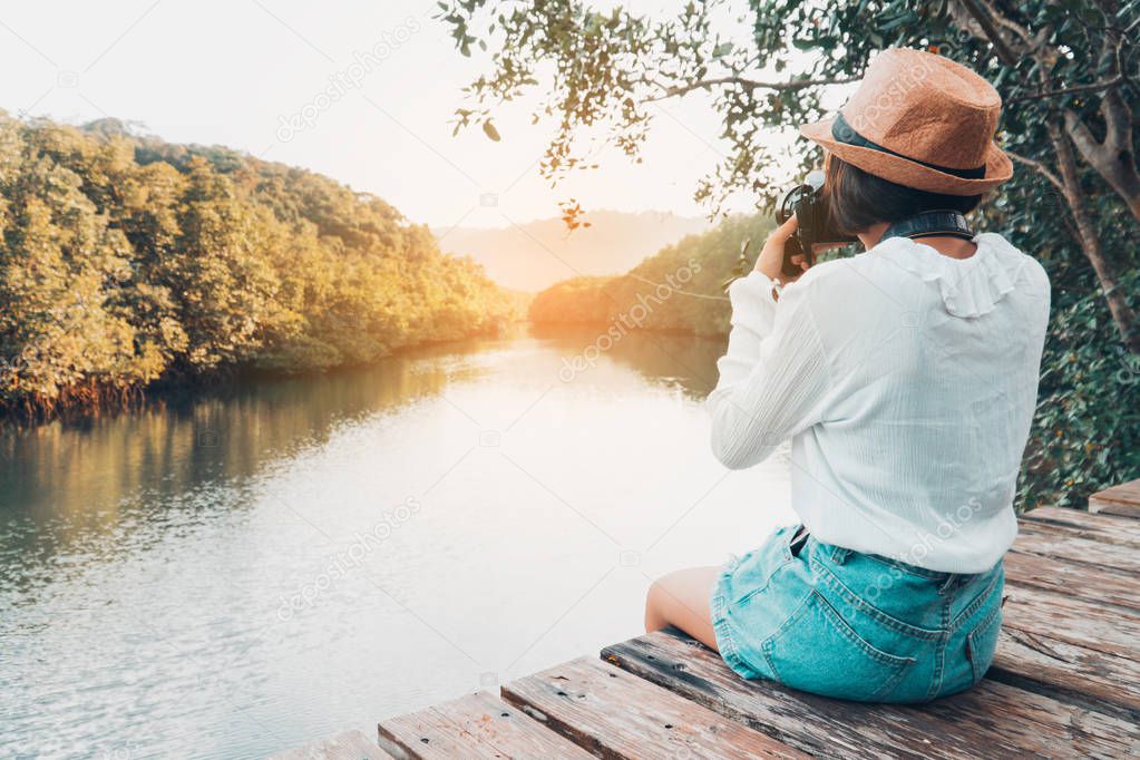 Cute girl enjoy with the nature resting and looking on the river.