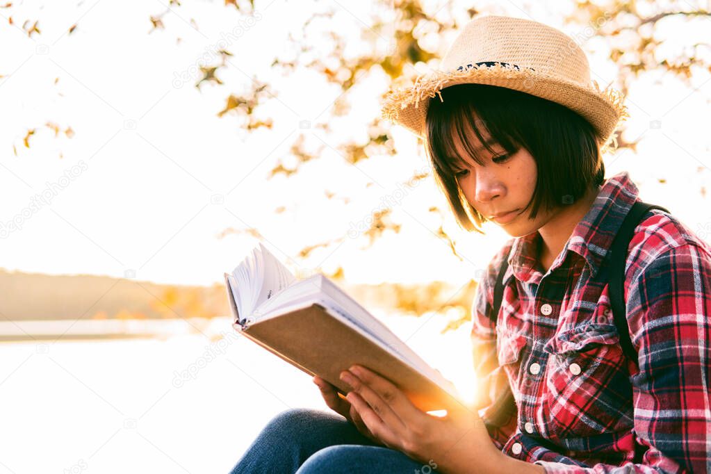 Cute girl reading a book .