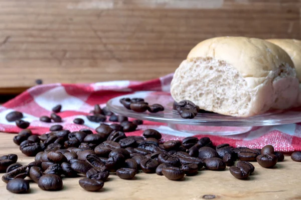 Coffee and bread wooden background