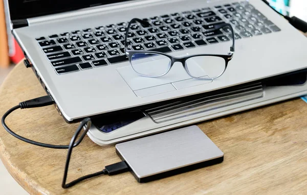 Notebook grey modern black keyboard with hdd grey and spectacles