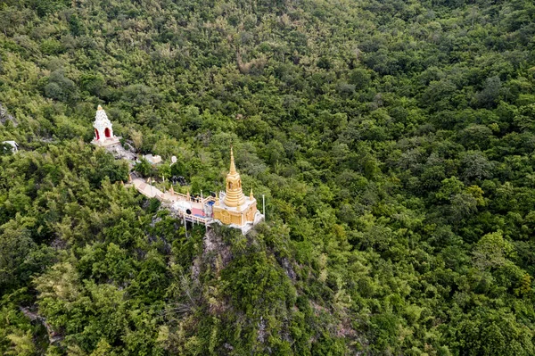 Golden pagoda on hill in tropical rainforest on Wat Ban Tham