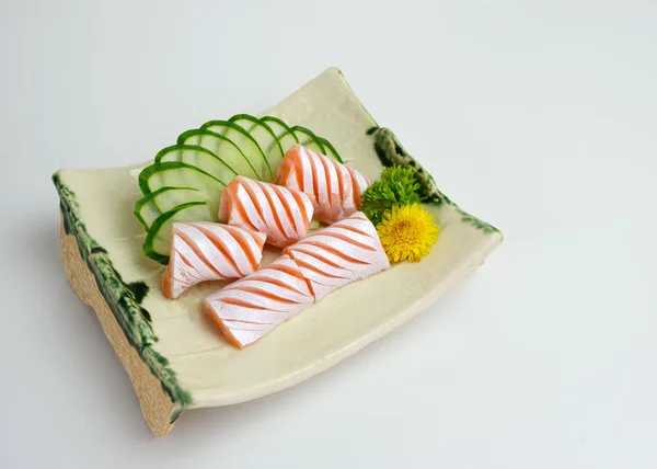 Sliced raw Salmon sac sashimi with cucumber on plate — 스톡 사진