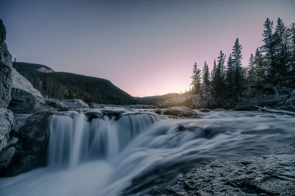 Waterfall rapids flowing on rocks in pine forest on evening at E — 스톡 사진