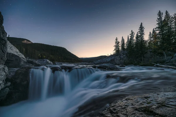 Waterfall rapids flowing on rocks in pine forest on evening at E — 스톡 사진