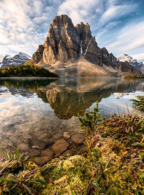 Rocky mountain reflection on Cerulean lake in Assiniboine provin clipart