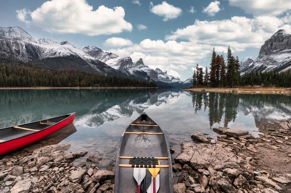 Canoe anchored on Spirit Island with Canadian Rockies in Maligne Lake at Jasper national park, Canada