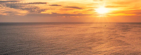 Panorama of Sunset over horizon on tropical sea with boat