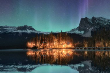 Kanada Yoho Milli Parkı 'ndaki Emerald Gölü' nde Aurora borealis ile aydınlatılmış ahşap kulübe.