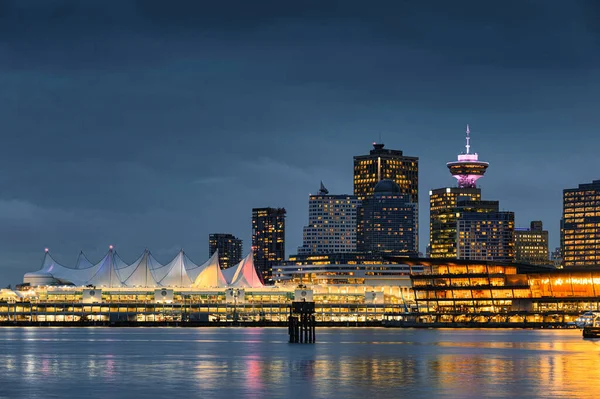 Cityscape of Modern buildings illumination with central market on coastline at Stanley park, Vancouver, Canada