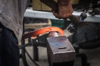 Sıcak demir çekiç bir demirci 