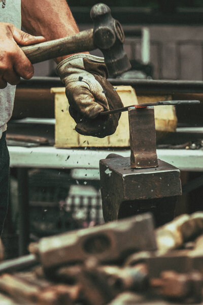 A blacksmith hammering hot iron 
