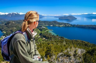 Girl admiring the beauty of argentinian Lake District clipart