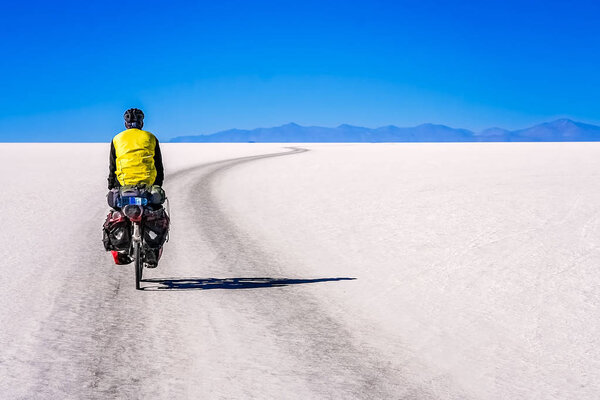Cyclist travelling through the Salar de Uyuni 