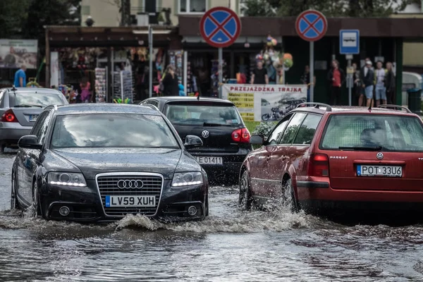 Su basmış bir sokakta arabalar