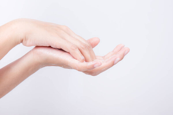 Asian girl hands are washing with soap bubbles on white background