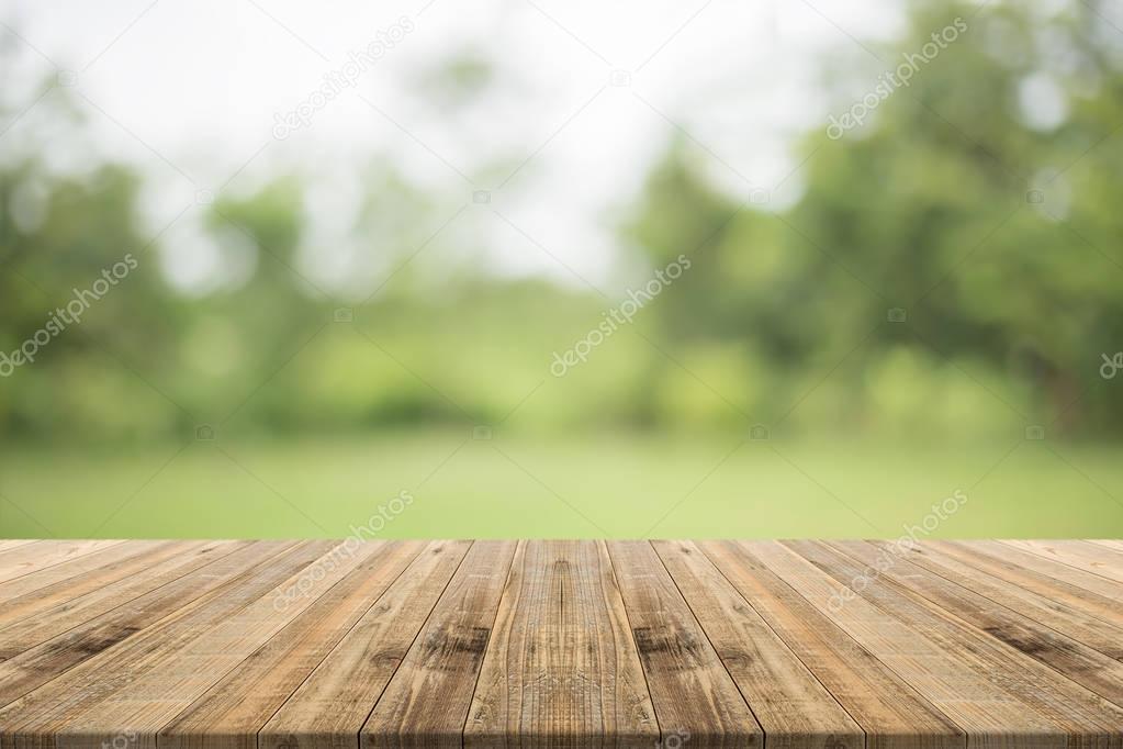 Wood table top on nature green blurred background