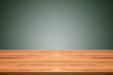 Empty teak wood table top on green gradient background clipart