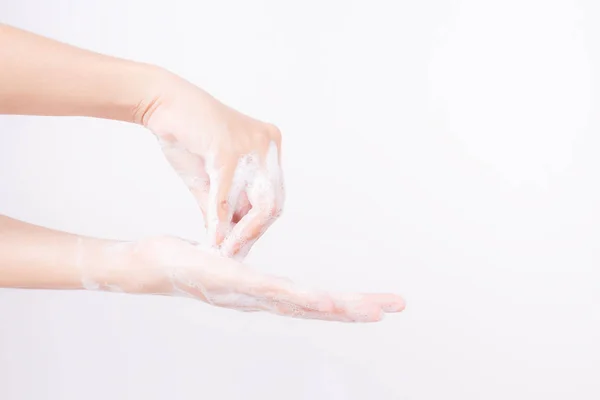 Asiático chica manos son lavado con jabón burbujas en blanco fondo — Foto de Stock