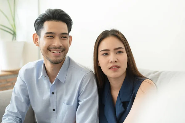 Asian couple sitting on the couch in the psychiatrist room to consult mental health problems by doctor